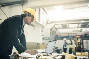 An architect using his computer at a construction site