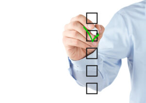 Businessman tiks boxes on his checklist for selecting an ERP provider