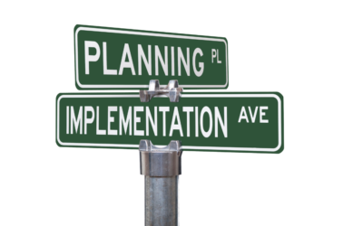 Sign showing planning and Implementation at a crossroad