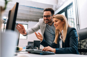 Two business colleagues learning together online