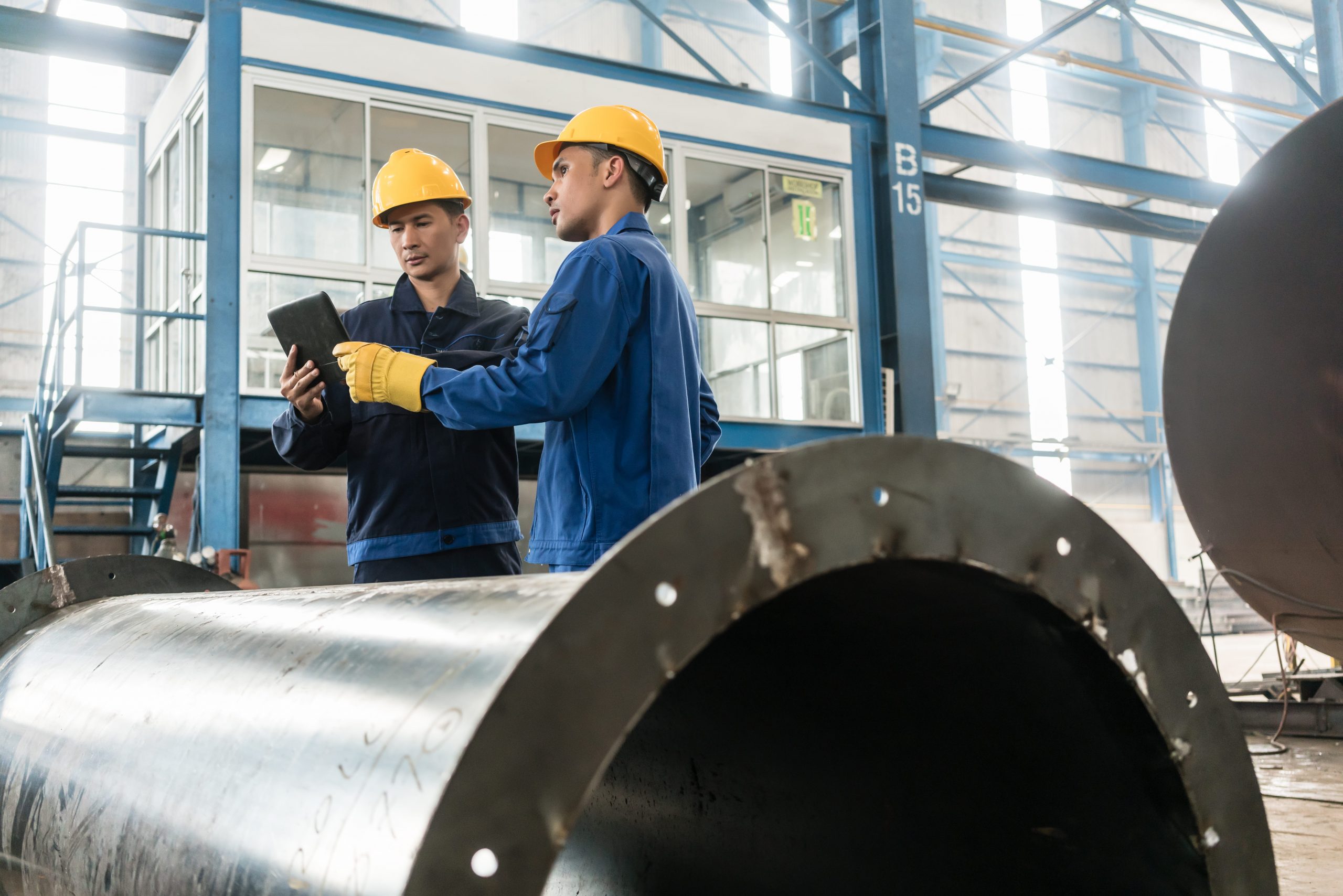 Two men in a factory using technology to solve their their business challenges