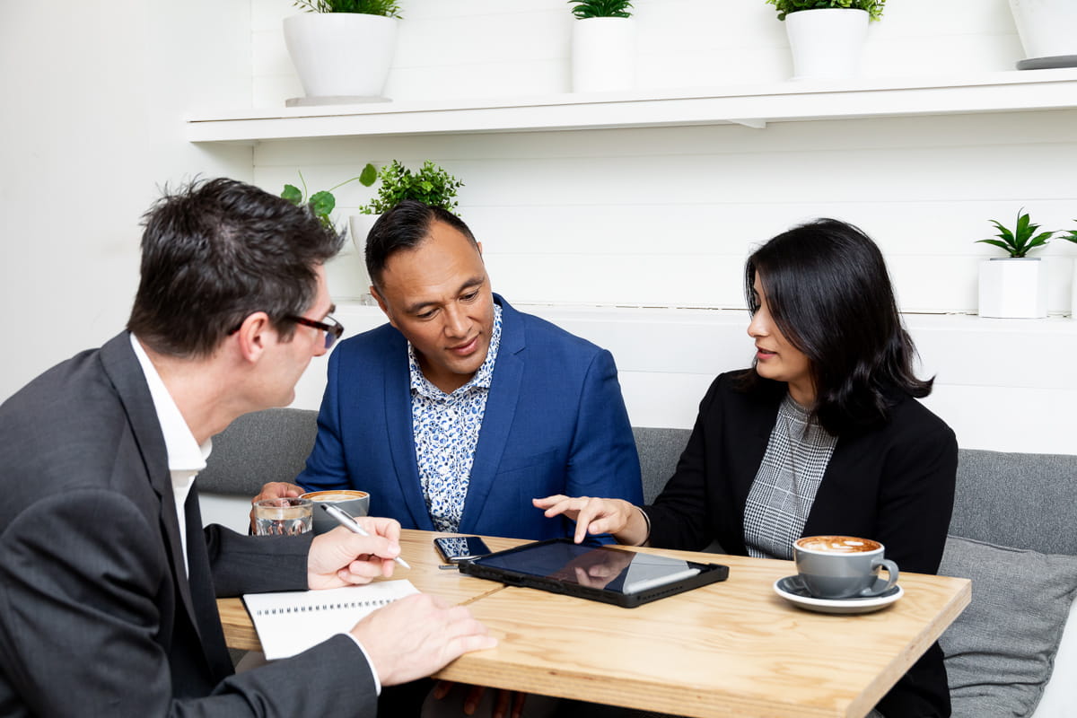 Three Precise employees meeting in a coffee shop about how they can best support of of our Epicor customers