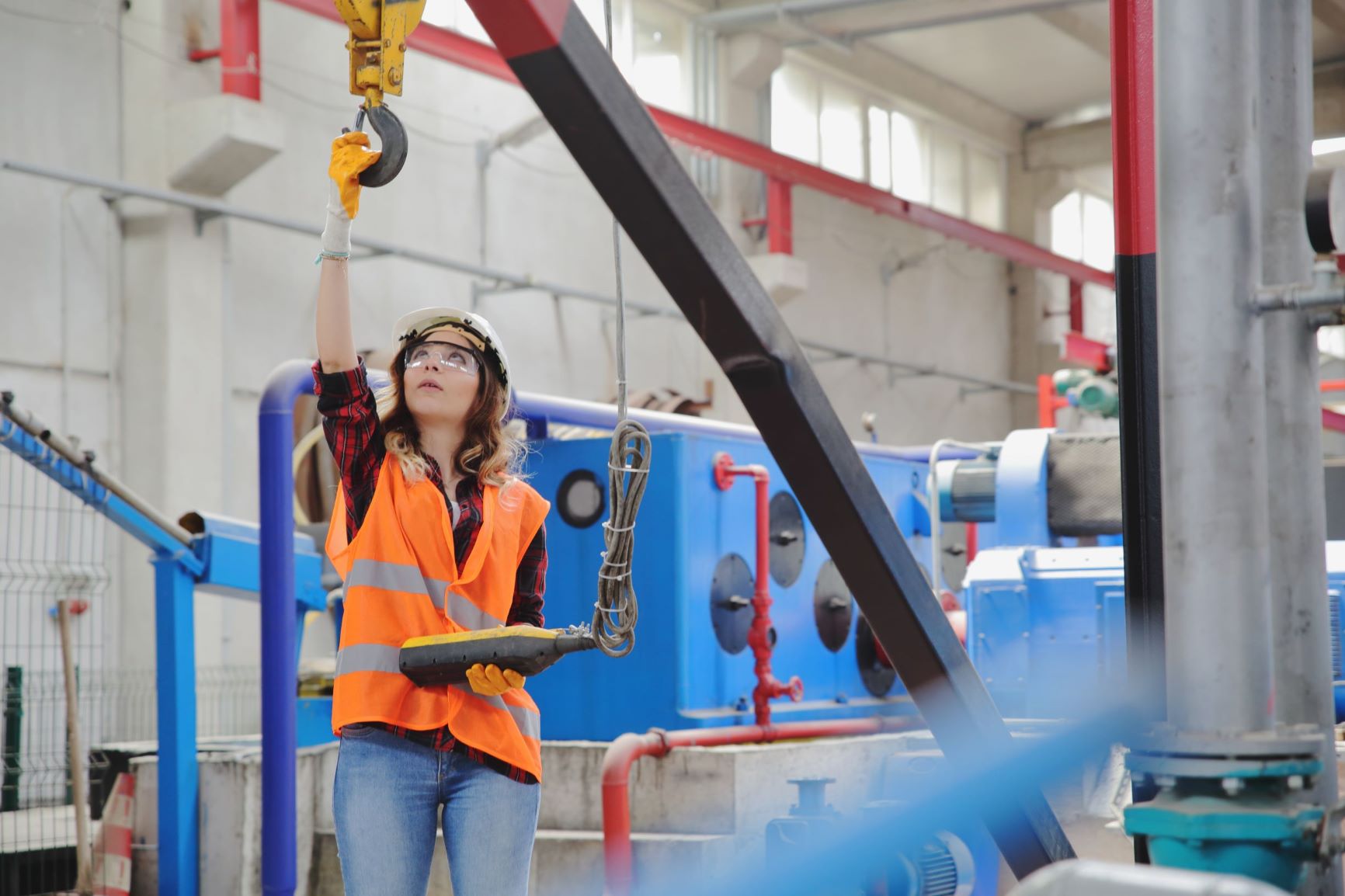 A woman working on equipment in a factory